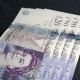 A photograph of twenty pound notes.