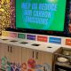 Recycling bin station with a big screen that displays the message 
